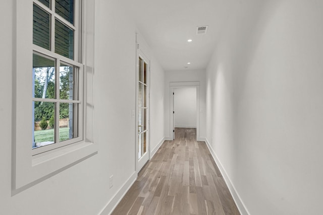 corridor with light hardwood / wood-style flooring