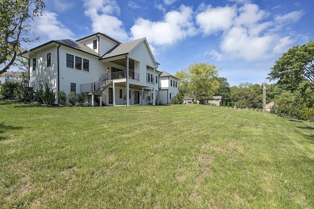 rear view of house featuring a lawn