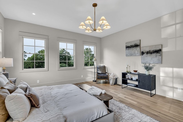 bedroom with an inviting chandelier and wood-type flooring