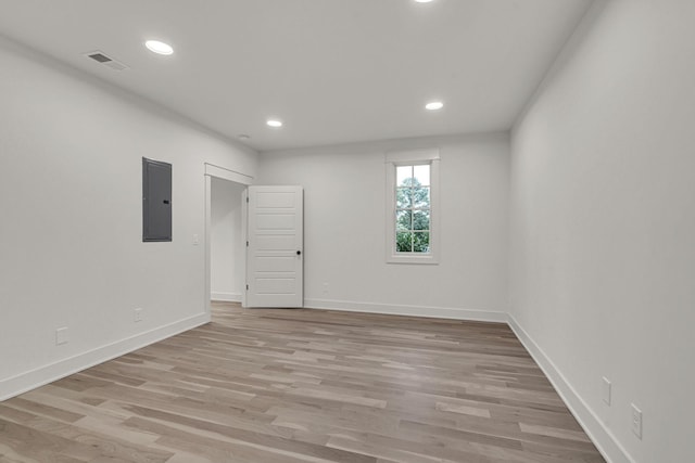 empty room featuring light hardwood / wood-style flooring and electric panel