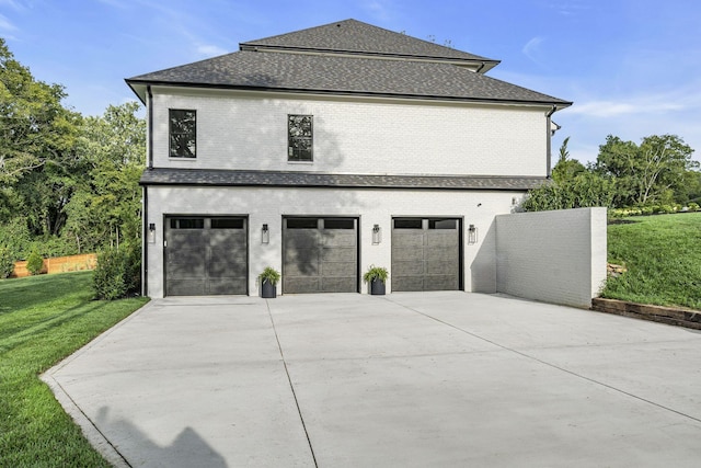 view of side of property with a garage and a yard