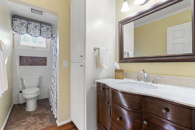 bathroom featuring toilet and vanity