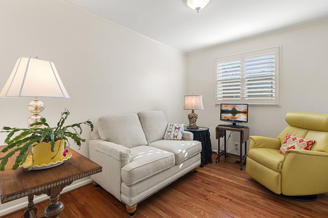 living room with dark hardwood / wood-style flooring and crown molding