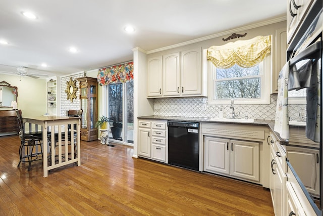 kitchen featuring ceiling fan, sink, black dishwasher, and ornamental molding