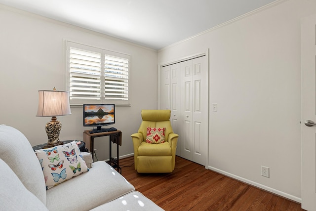 living area featuring dark hardwood / wood-style floors and ornamental molding