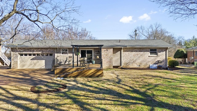 view of front of property with a front yard and a garage