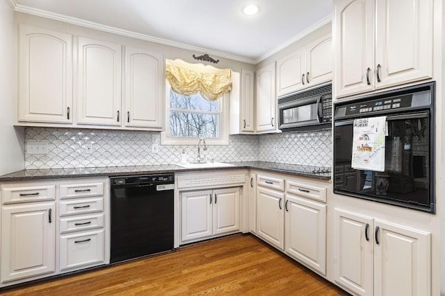 kitchen with light hardwood / wood-style floors, black appliances, sink, crown molding, and white cabinets