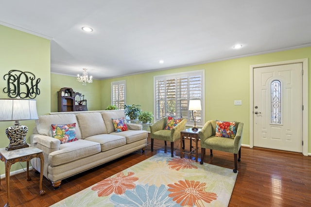 living room with a chandelier, crown molding, and dark hardwood / wood-style floors