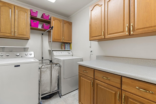 laundry area with cabinets, crown molding, and washing machine and clothes dryer