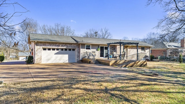 view of front facade featuring a front yard, a pergola, and a garage