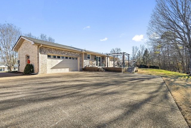 view of front facade featuring a garage and a pergola