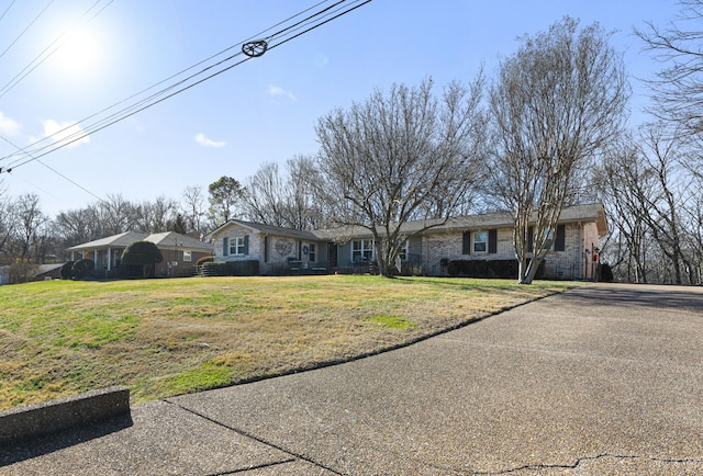 ranch-style home featuring a front yard