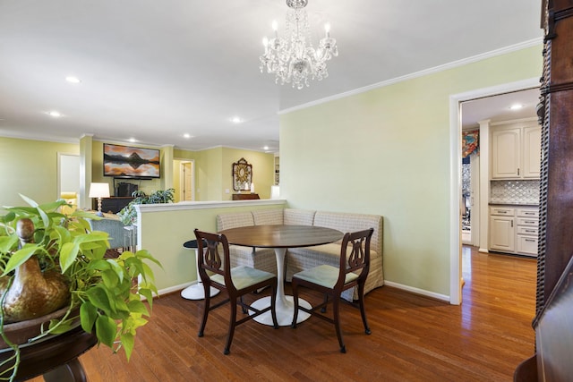 dining room with ornamental molding, a chandelier, and wood-type flooring