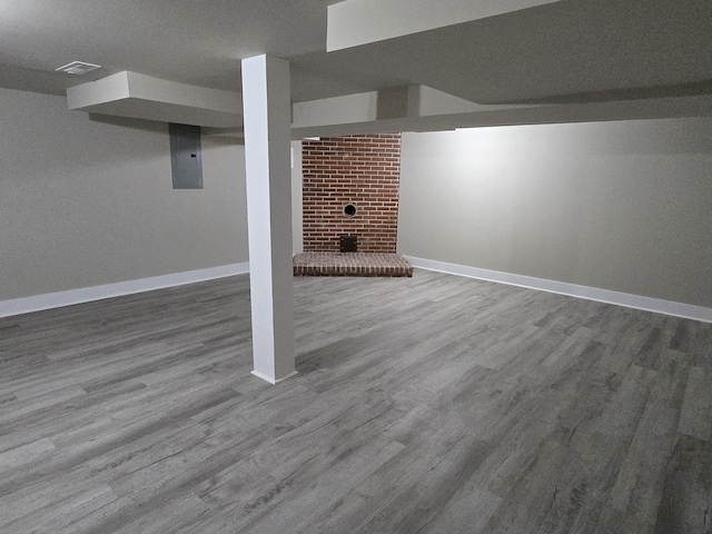 basement with a fireplace and hardwood / wood-style flooring