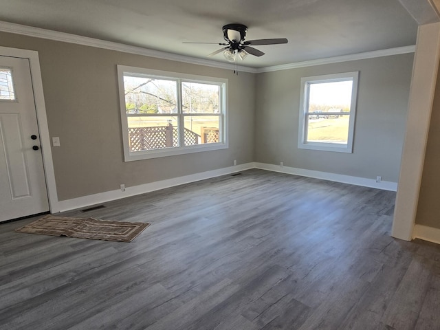 foyer entrance featuring ceiling fan, plenty of natural light, crown molding, and dark wood-type flooring