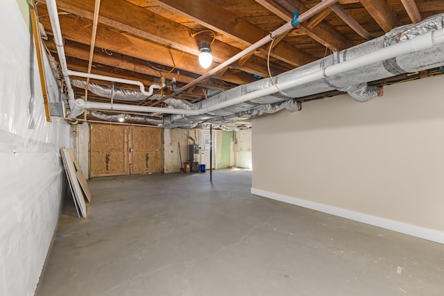 unfinished below grade area featuring gas water heater and baseboards