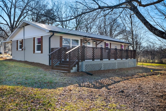 view of front of house with brick siding and a front lawn