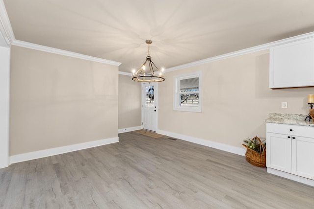 unfurnished dining area featuring baseboards, light wood-type flooring, a notable chandelier, and crown molding