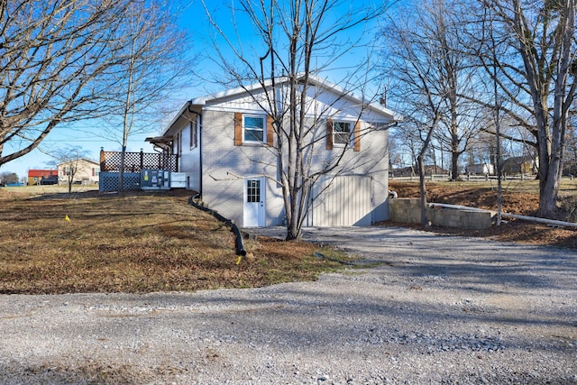 view of home's exterior featuring brick siding and driveway