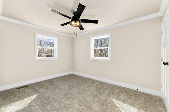 carpeted empty room with plenty of natural light, ornamental molding, and baseboards