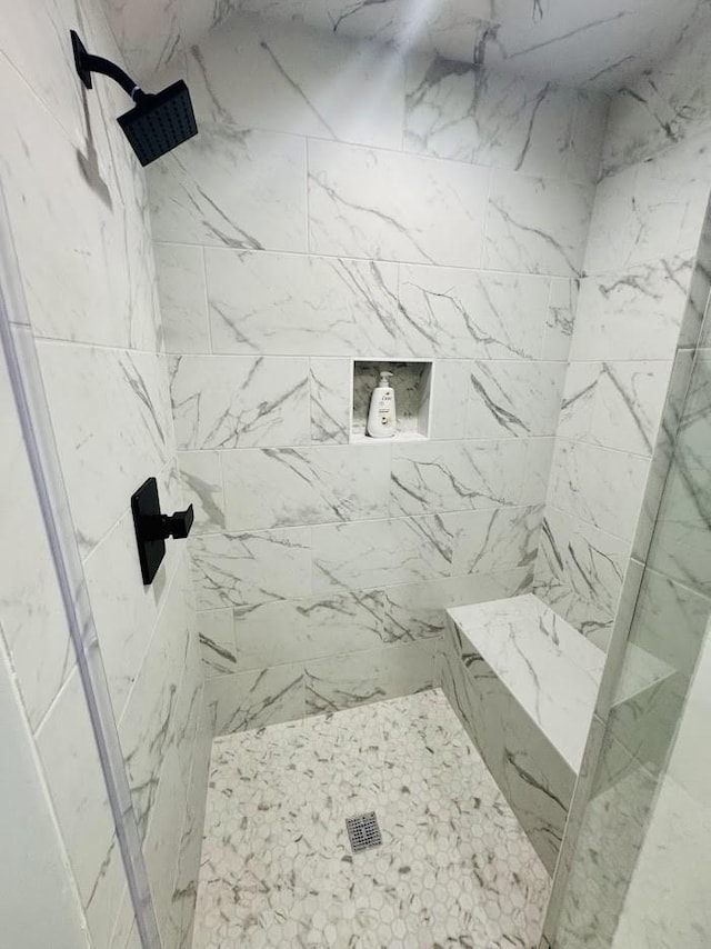 bathroom with tiled shower