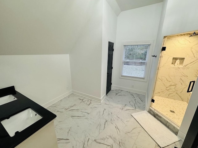 bathroom featuring lofted ceiling, a shower with shower door, and vanity