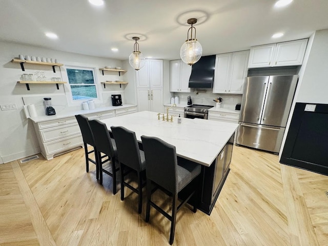 kitchen featuring custom exhaust hood, white cabinets, an island with sink, and stainless steel appliances