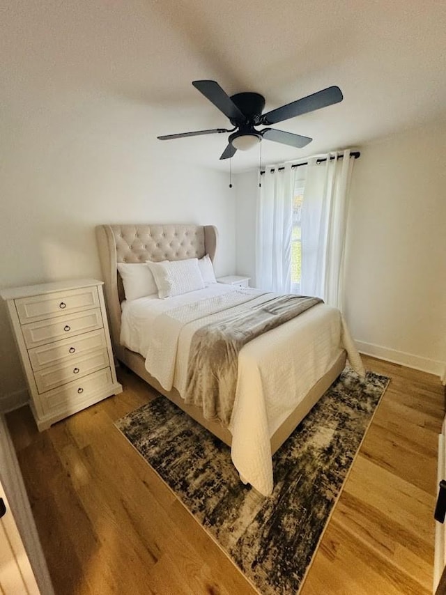 bedroom featuring ceiling fan and dark hardwood / wood-style floors