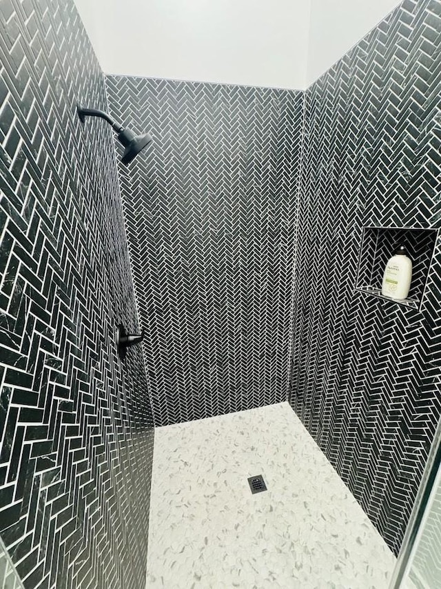 bathroom with tiled shower