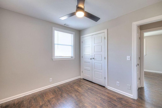 unfurnished bedroom featuring ceiling fan, a closet, and dark hardwood / wood-style floors