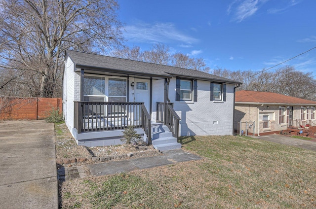 bungalow with a front lawn and a porch