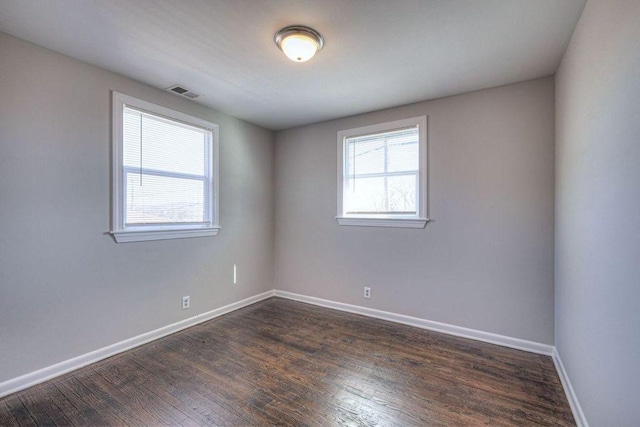 empty room with dark hardwood / wood-style floors