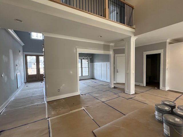 interior space with french doors, a high ceiling, and plenty of natural light