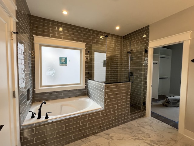 bathroom featuring recessed lighting, marble finish floor, a garden tub, and a shower stall