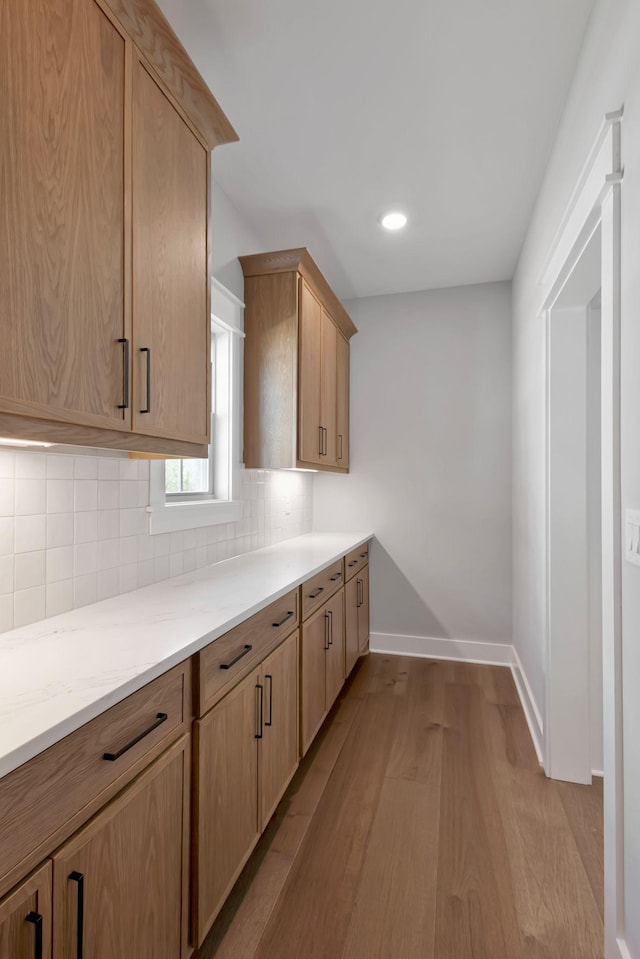 3025 Shady Forest Dr, Murfreesboro, TN 37128 - kitchen featuring tasteful backsplash, wood finished floors, light stone countertops, and baseboards