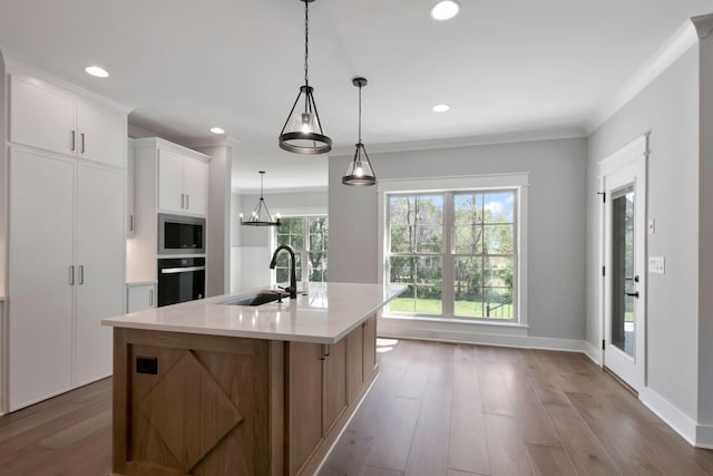 3025 Shady Forest Dr, Murfreesboro, TN 37128 - kitchen featuring wood finished floors, a sink, oven, light countertops, and stainless steel microwave