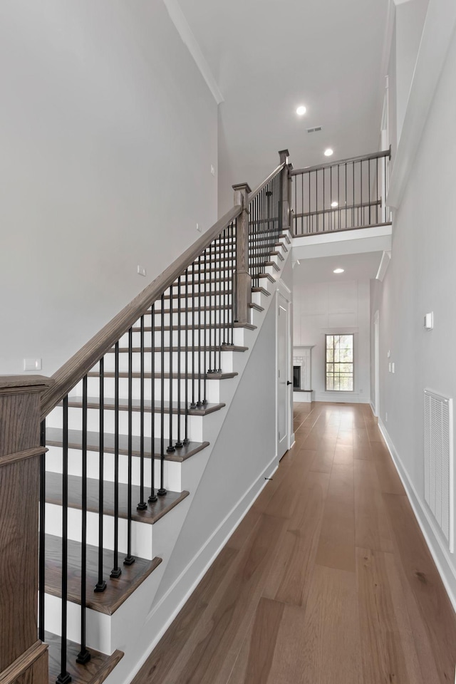 3025 Shady Forest Dr, Murfreesboro, TN 37128 - staircase featuring recessed lighting, a high ceiling, wood finished floors, visible vents, and baseboards