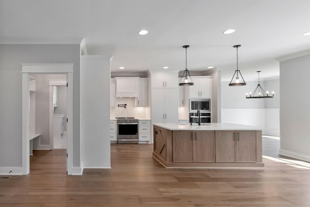 3025 Shady Forest Dr, Murfreesboro, TN 37128 - kitchen with stainless steel appliances, light countertops, a sink, light wood-style floors, and white cabinetry
