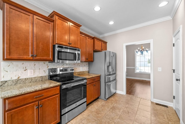 kitchen with crown molding, light tile patterned floors, appliances with stainless steel finishes, light stone countertops, and backsplash