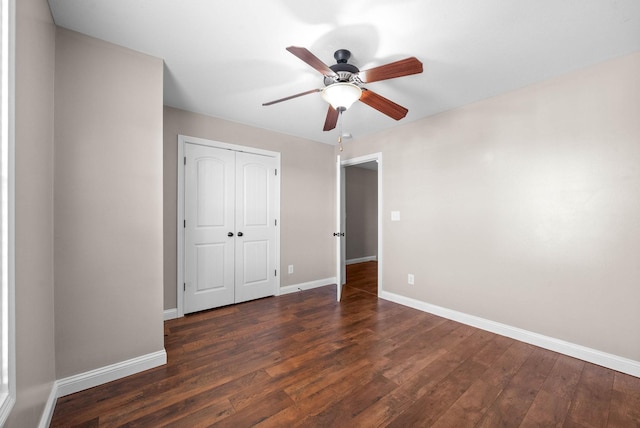 unfurnished bedroom with dark hardwood / wood-style floors, a closet, and ceiling fan