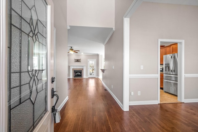 entrance foyer featuring crown molding, ceiling fan, and light wood-type flooring