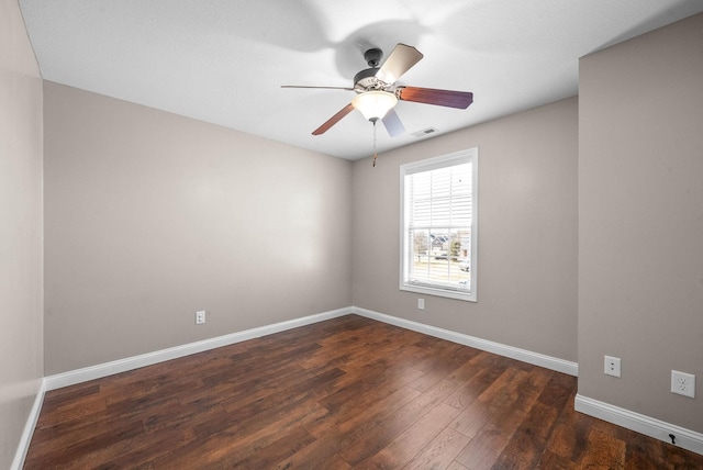 unfurnished room featuring dark wood-type flooring and ceiling fan