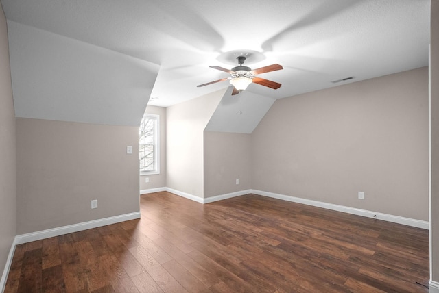 additional living space featuring ceiling fan, lofted ceiling, and dark hardwood / wood-style flooring