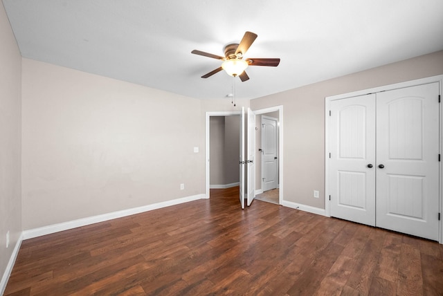 unfurnished bedroom with a closet, dark hardwood / wood-style floors, and ceiling fan