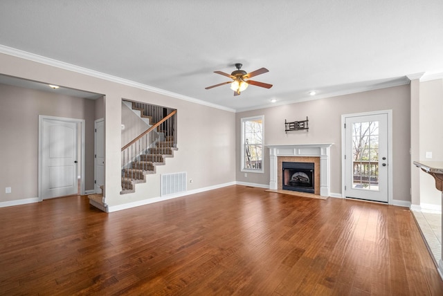 unfurnished living room with ornamental molding, wood-type flooring, and a wealth of natural light