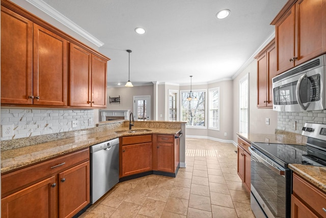 kitchen with tasteful backsplash, appliances with stainless steel finishes, sink, and pendant lighting