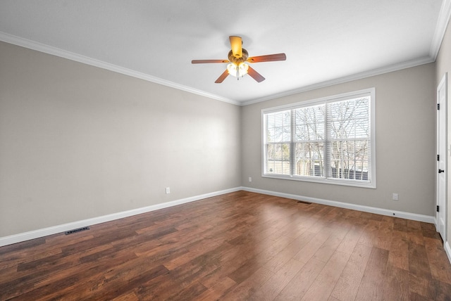 spare room with crown molding, ceiling fan, and dark hardwood / wood-style flooring