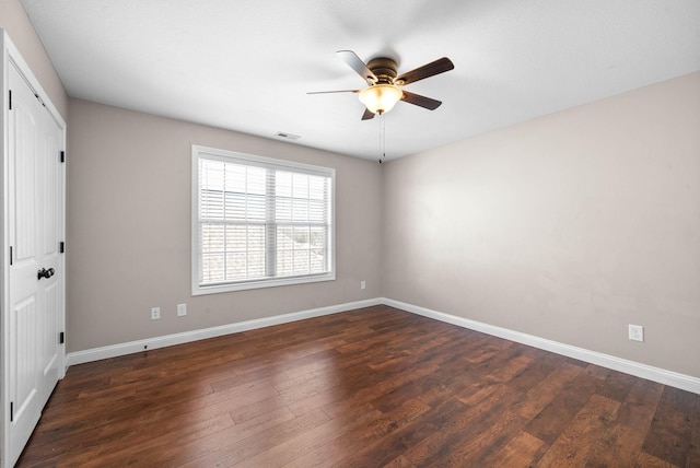 unfurnished room with dark wood-type flooring and ceiling fan