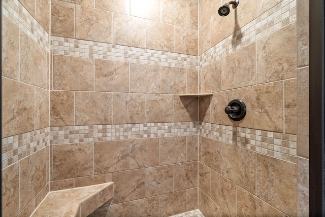 interior details with a tile shower