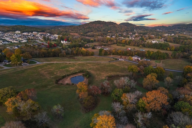 aerial view at dusk featuring a mountain view